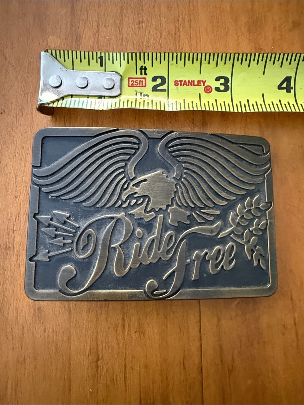 Metal “Ride Free” rectangular belt buckle (no belt)